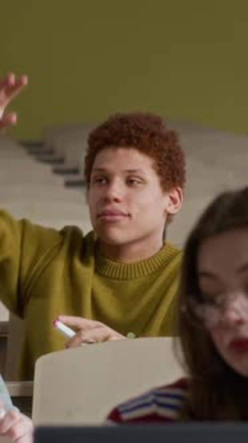 Students Raise Hand in Classroom Setting