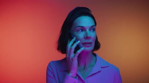 Woman Smiling and Talking on Phone with Colorful Lights