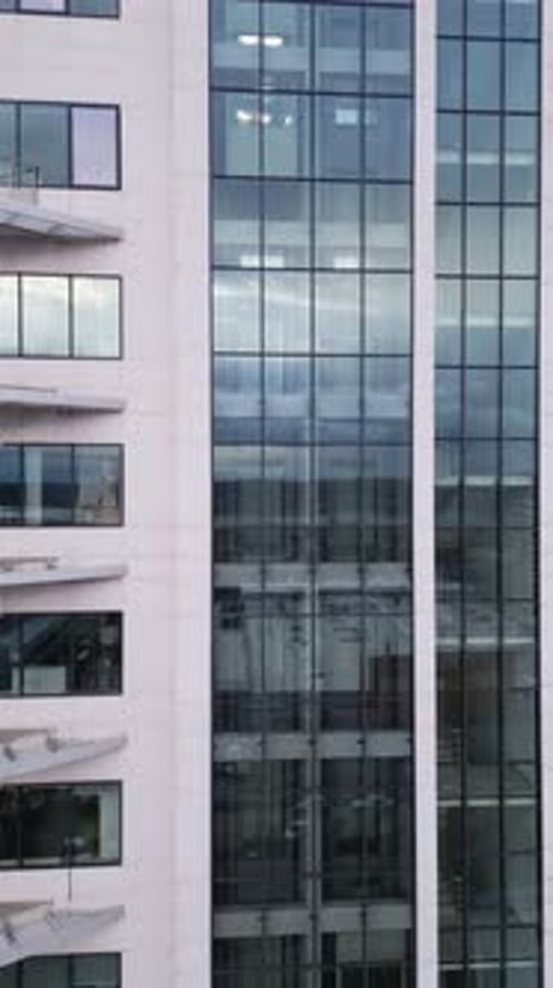 Aerial View of Moving Elevator Walls and Windows of Contemporary Business Center at Evening