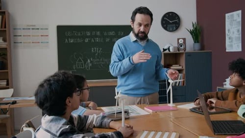 Teacher Explains Wind Turbine Models to Attentive Students