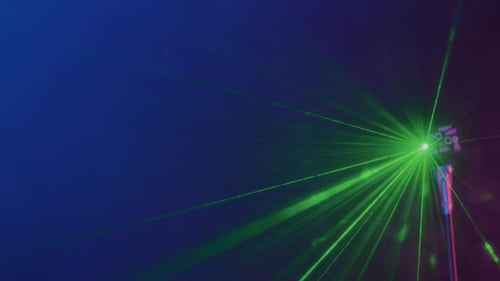 Laser Projector Shining Green Lights in Dimly Lit Room at Night