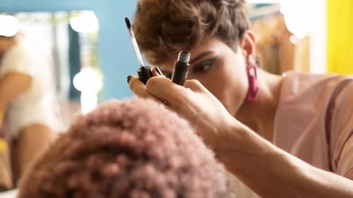 Makeup Artist Applying Eye Makeup to Client