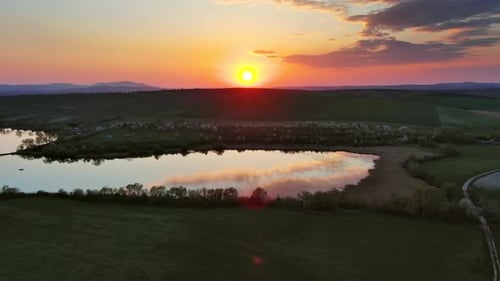 Sunset Wavy Hills with Fields and Pond