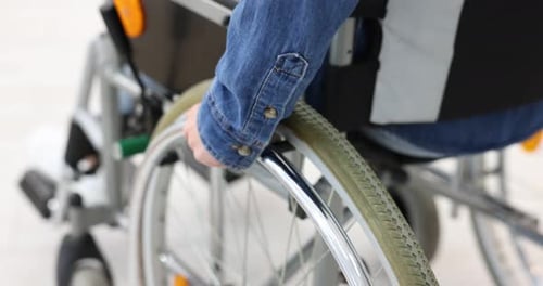 Woman using wheelchair at home, closeup view