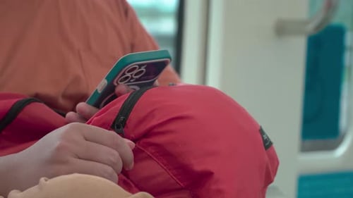 Close-up of a person using a smartphone in public transportation