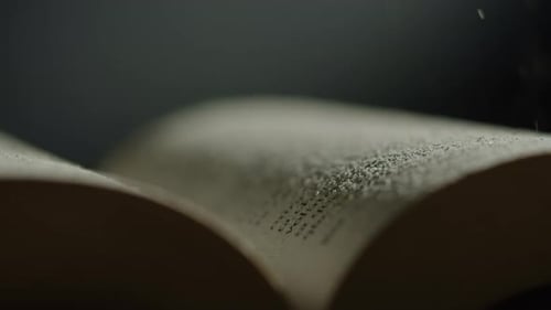 Close Up of Book with Falling Particles