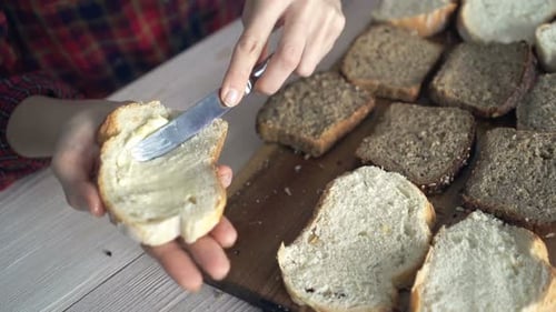 Spreading Butter on Bread at Table
