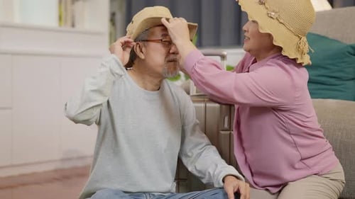 Senior Couple Preparing for Travel at Home