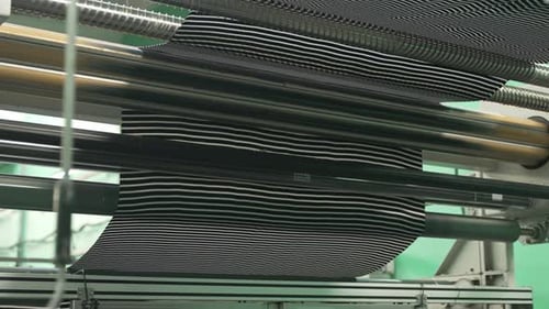 Black and White Striped Fabric Moving Through Machine