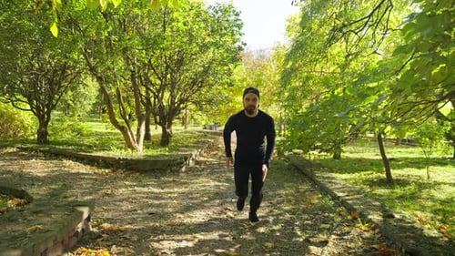 A Young Sportsman Runs in the Park