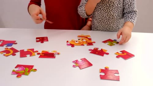 Children Collaborating on a Colorful Puzzle at Home