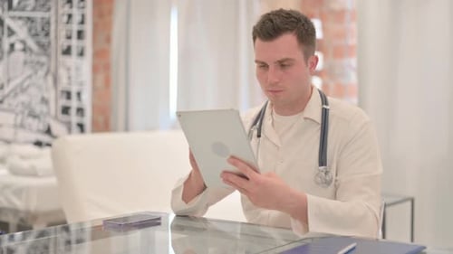 Male Doctor using Tablet in Clinic