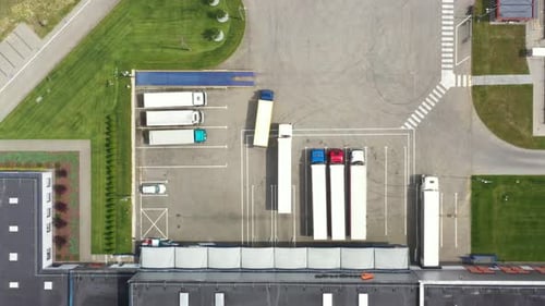 Car moving on modern cable stayed bridge over sea in developed city aerial view