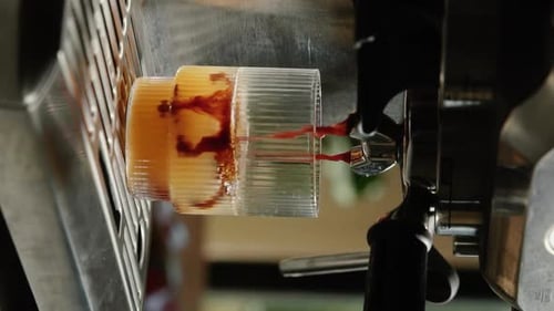 Espresso Machine Fills Glass with Iced Coffee Drink