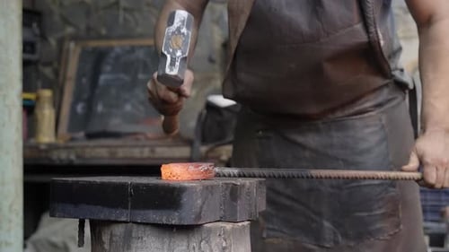 Blacksmith Manually Forging the Molten Metal Close Up of the Hammer Striking