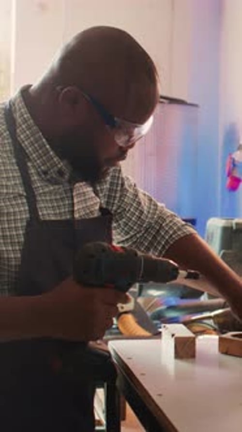 Vertical Video Craftsperson Sinks Screws Into Wood Block with Electric Tool