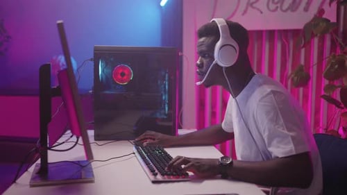 Young Adult Playing Computer Games at Night