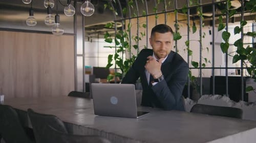 Portrait of Male Businessman Working in a Modern Office at a Laptop Portrait of a Male Boss in a