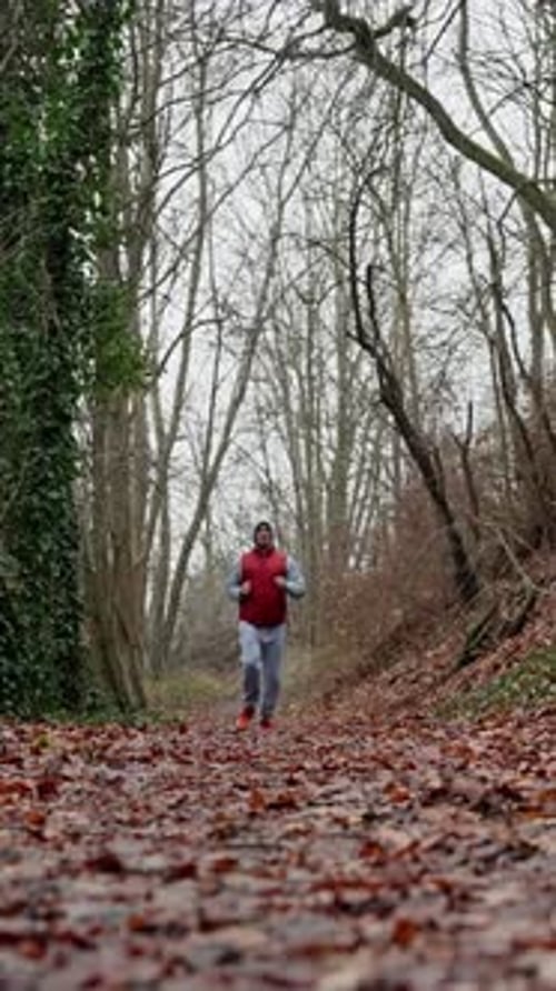 Man Running Outdoors Man In Casual Sportswear Running On Trail Male Athlete In Red Vest Jogging