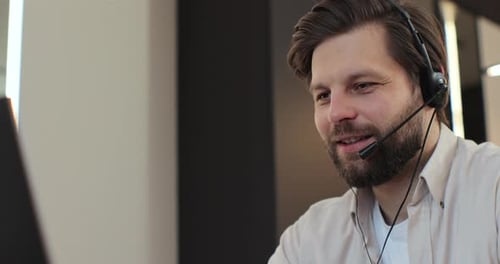 Close Up Man with Headset Using Laptop Talking Working Customer Support Service Operator at Home