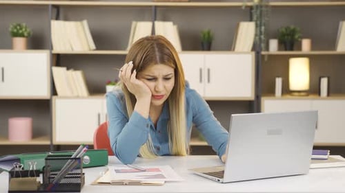 Woman Experiencing Tooth Pain While Using Laptop