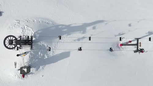 Ski Resort Lift with Chairlift on Snowy Mountain Slopes, Top down Aerial