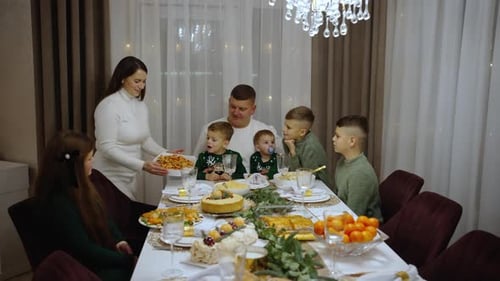 Large Family Together at Home Celebrates Dinner