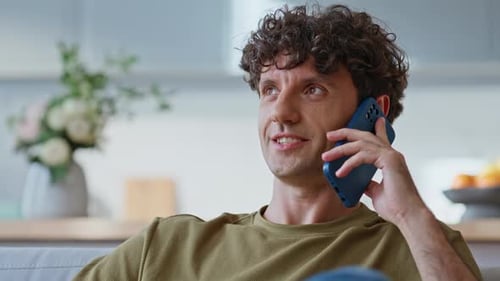 Young Adult Relaxing at Home, Chatting on Phone