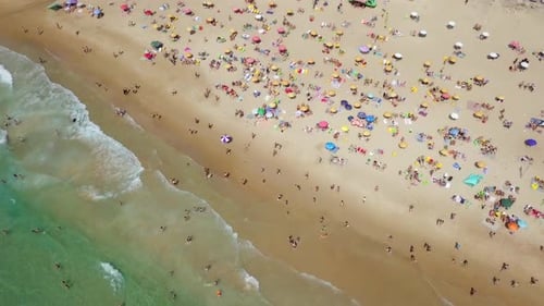 Mediterranean beach during summer with people in the water
