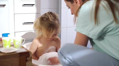 Child Enjoys Bath with Bubbles and Loving Care