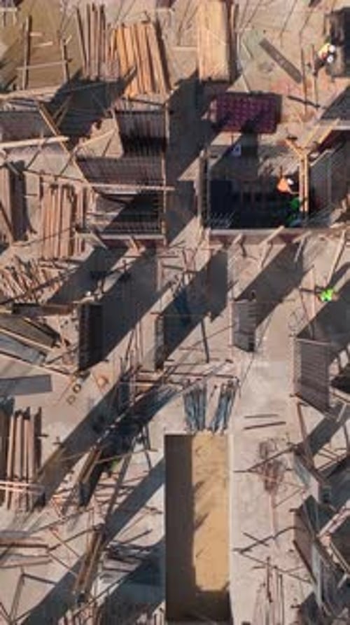 Vertical Video Construction Progress in Action As Workers Build Walls on an Active Site Full of