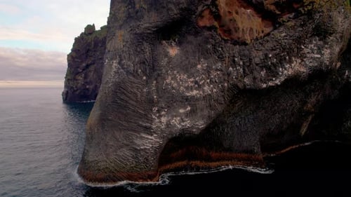 Incredible Elephant Rock Face Close Up Drone Iceland. Aerial Rise Ocean Coast Epic Stone Formation.