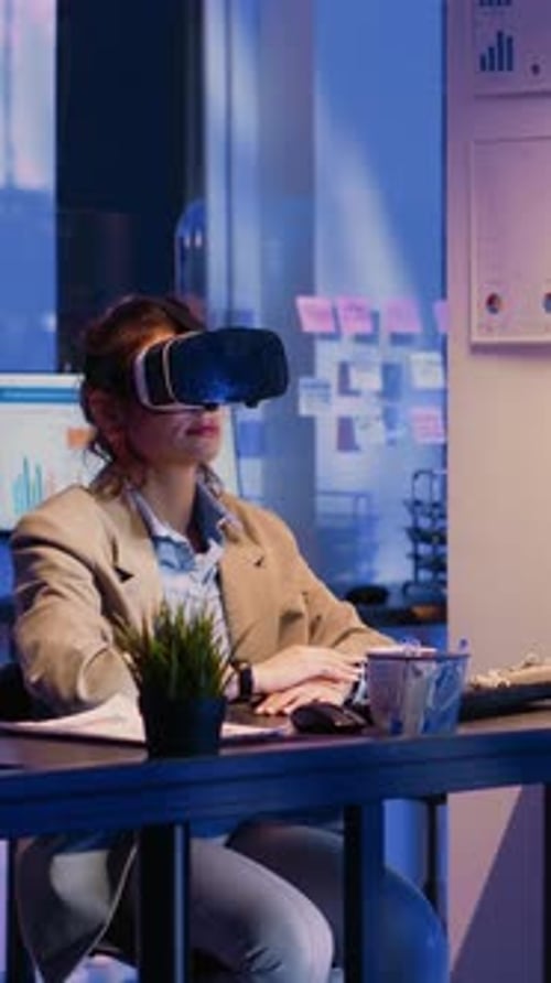 Vertical Video Young Worker Wearing Virtual Reality Goggles in Office