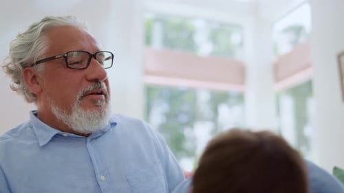 Grandfather and Grandson Embrace Lovingly Indoors