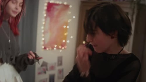 Girls Laughing Jumping on Pink Bed Indoors