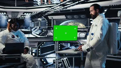 Astronaut Monitoring Diagnostics on Green Screen Display Talking to Colleague