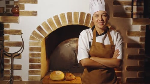 Smiling Female Chef With Freshly Baked Bread