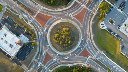 Top View of City Street Traffic on Roundabout Intersection with Fast Moving Cars Timelapse of Urban