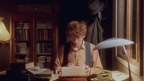 Young Adult Typing on Antique Typewriter
