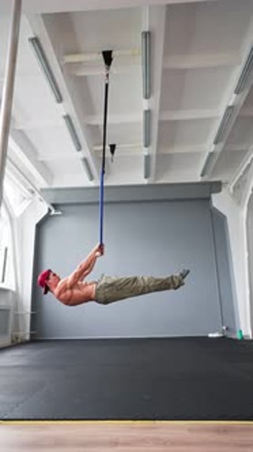 Athletic Muscular Man Naked Waist Doing Exercises From Workout on Ring in Gym
