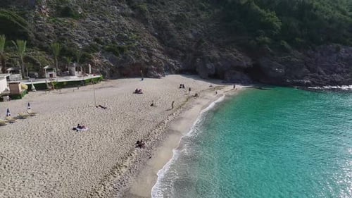 Aerial Video of a Beautiful Seaside With a White Sand Beach Shallow Azure Water and a Bright Blue