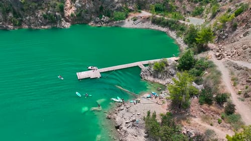 Aerial View People Paddleboarding in the Large Green Canyon Relaxing and Having Fun in the Summer