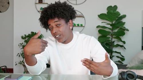 Young Adult Gesticulating While Talking to Camera