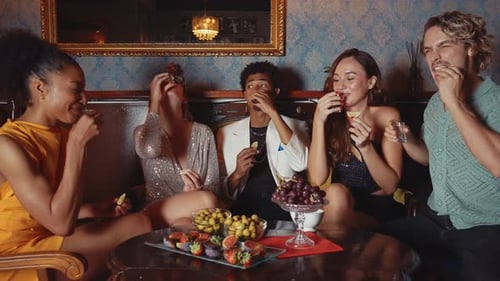 Happy friends celebrating in a cocktail bar