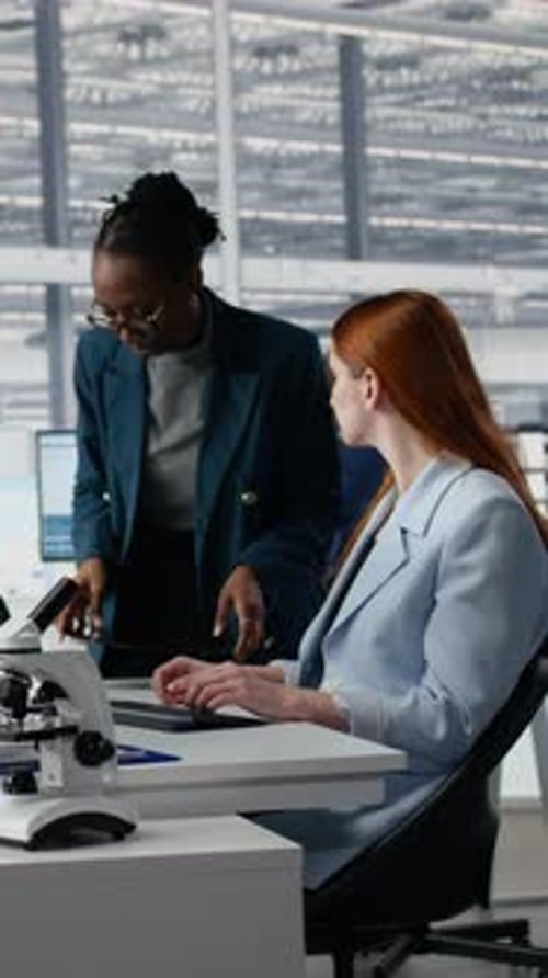 Vertical Video Women Working Together in Office to Examine Semiconductor Substrate