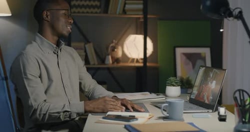 African American Businesspeople Talking Discussing Work During Virtual Meeting with Laptop in Office