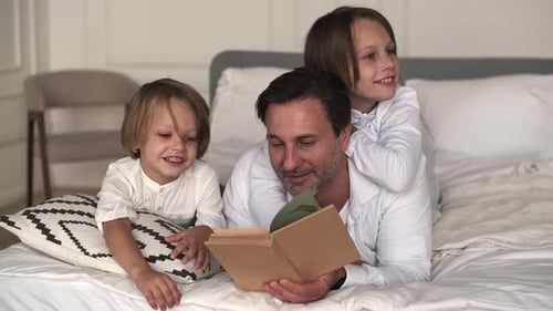 Father Reading a Book with His Children