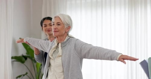 Senior Woman Practicing Yoga with Assistant