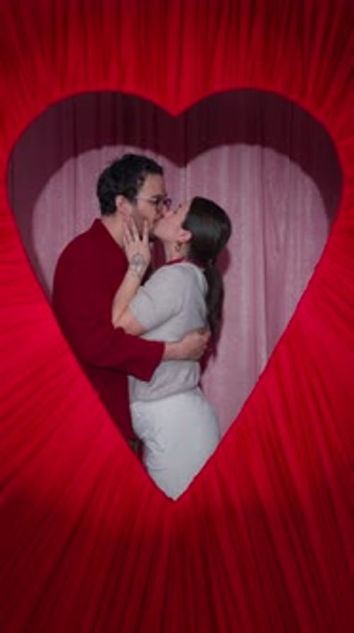 Latin Couple Hugging and Kissing in Heart Frame Valentine Booth