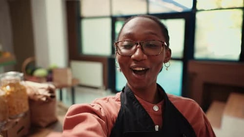 Cheerful Woman Filming in Urban Food Store